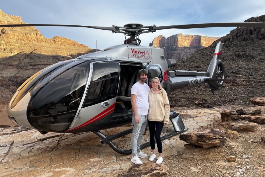 Will and Amie beside a helicopter at the Grand Canyon